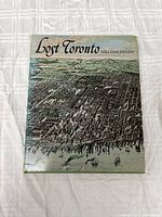 Front cover of the Lost Toronto hardcover book showing an illustrated aerial city view and the title with author name