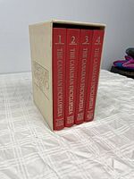 Front view of 4 volumes of The Canadian Encyclopedia with beige slipcase.