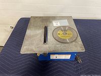 Top view of metal tile saw cutting surface with Bosch diamond blade placed on top.