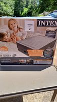 Photo of box packaging showing Intex queen inflatable mattress with Fiber-Tech construction, 22-inch high-rise.