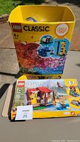LEGO Classic large box (1500 pieces) and LEGO Creator 3-in-1 boxed set on table in sunlight