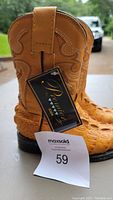 Front side view of a single children's cowboy boot showing stitched decorative design and Panama Jack tag