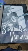 Full view of the framed black and white photo of Stevie Ray Vaughan playing guitar.