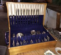 Full view of the open wooden flatware storage box showing approx. 64 pieces of silver plate flatware in the Springtime pattern.