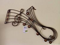 Music-themed steel wall art featuring musical notes and treble clef, showing full front view.