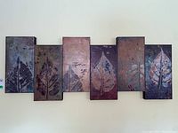 Full front view of mixed media artwork composed of six joined canvases, each canvas with textured, earthy leaf designs.