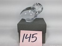 Crystal owl displayed on a black box with lot number card replacing description.