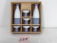 Top-down view of the 7-piece Noritake sake set neatly arranged in a wooden box.