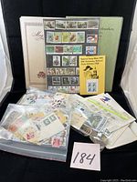 Full view of album and loose bags containing the stamps, showing variety of stamps and the special exhibition block