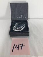 Steuben eagle hand cooler displayed in its original box.