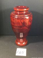 Front angle photo of tall reddish-brown wood vase with shellac finish and visible wood grain.