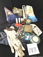 Overall lot showing gloves, scarves, compact, mascara, perfume, sunglasses, jewelry, and mirror