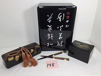 Set of three lacquer boxes and two chopsticks displayed together, showing overall lot content and condition