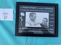 Front view of one black 8x12 photo frame with anniversary message, holding 4x6 photo.