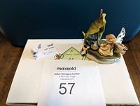 Two views of one ceramic fairy figurine on white box with labels showing 'Joyful Journey' and 'Butterfly Fairies' branding. Includes auction lot number.
