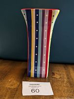 Side view of a Pick Me Up Bouquet vase showing colorful vertical stripe pattern with dots and red rim.
