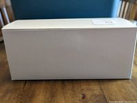 White rectangular gift box shown from front side, flat boxed