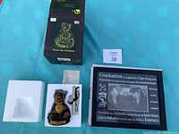Boxed Boyd's Bear graduation figurine with styrofoam insert and small stand accessory.