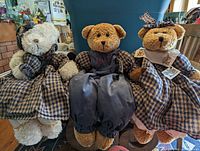 Front view of the three shelf sitter bears seated, showing their handmade outfits and wood block bodies.