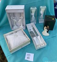 Overview of complete wedding set showing all items and original packaging on a blue fabric background.