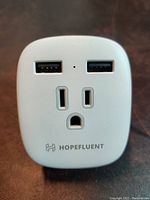 Front view showing two USB ports and two standard North American plug inputs with Hopefluent branding