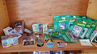 Wide view of vintage baseball and theme trading cards including several sealed rookie packs plus loose cards and collectible pins