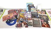 Wide view of Star Trek collectibles including trading cards, books, magazines, laser discs, and Captains Log notebooks spread on a table.