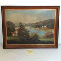Framed oil on canvas depicting a river landscape with homes and sailboats, showing the full artwork and frame.