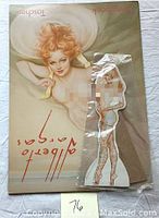 Photo showing the Alberto Vargas Posterbook next to the plastic-sealed pop-up nude figure.