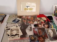 Overview of the lot showing Star Trek directory, photos, celluloid, t-shirts, and Christmas Carol poster