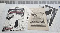 Overview of two art print portfolios, including 'Delicate Embrace' by Rick Bryant and other prints, laid out for display