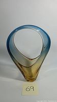 Hand blown glass basket vase with two-tone amber to blue gradient shown upright with a label '69'