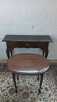 The image includes a view of the desk and the accent table placed next to each other showing their size comparison and design detail.