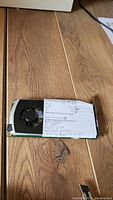 Front side of Nvidia graphics card showing cooling fan and a paper note with handwritten information.