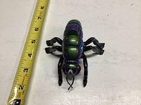 Top view of the 1984 Sectaurs Waspax action figure with a tape measure showing length approximately 5 inches.