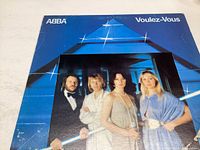 Front cover of ABBA Voulez-Vous vinyl record sleeve with band photo and album title.