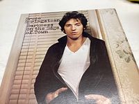 Front cover of Bruce Springsteen's Darkness on the Edge of Town vinyl record showing Bruce Springsteen in black jacket.