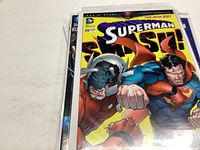 Superman comic book issue #20 with cover featuring Superman punching a character in armor, labeled The New 52 series.