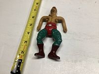 King Hiss Masters of the Universe figure laid flat with measuring tape showing about 6 inches tall, front view.