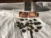 Overview photo showing old international paper money with a set of various old coins and a laminated hockey card.