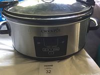 Front view of Crockpot slow cooker showing digital control panel with buttons and stainless steel exterior.
