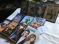 Photo showing a collection of 10 used DVD cases from various movies and series in different genres.