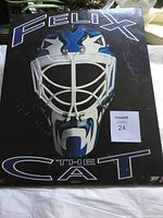 Large poster featuring Felix the Cat hockey goalie mask graphic and text 'Felix The Cat'. Worn edges visible.