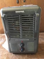 Front view of Shop Pro electric heater showing ventilation grill and control knobs