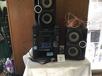 Sony compact stereo system with two speakers and wiring on a table