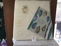 Front view of large white wedge pillow in plastic with instructional insert showing multiple usage positions