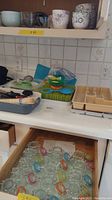 Top shelf showing assorted bowls in various colors and patterns.