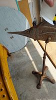 Close up of fish head showing detailed facial features and texture of rusted cast iron.