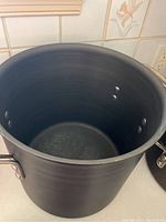 Close-up of tall stock pot inside showing interior finish.
