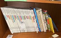 Shelf showing multiple books from the Value Tales series by Johnson along with The Guinness Book of Records 1992 and Save the Earth.